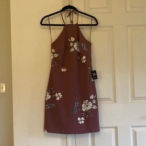 Pink mini dress with floral pattern; halter top with tie around the neck